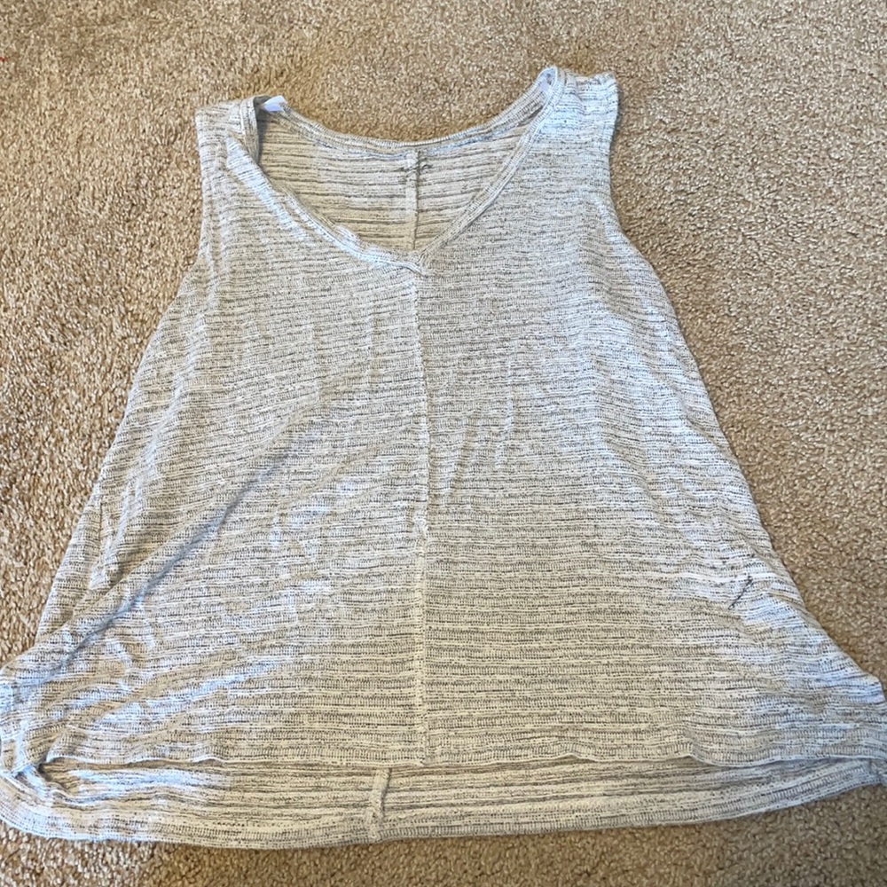 grayish top with v neck and slits on the bottom